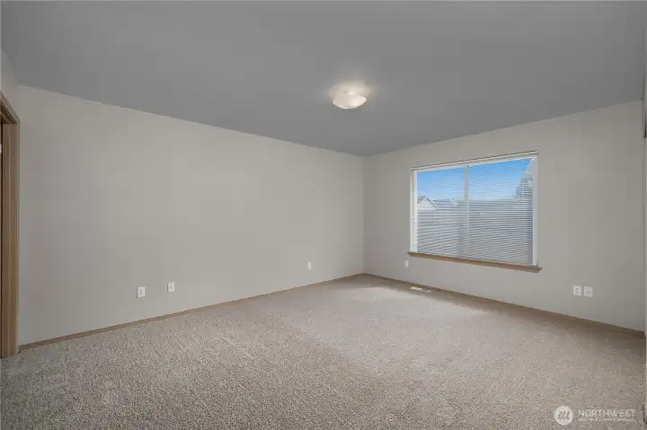 Spacious and well lit primary bedroom.