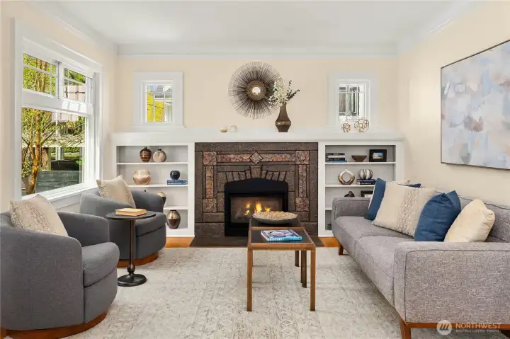 Big picture window and lovely windows on either side of the fireplace