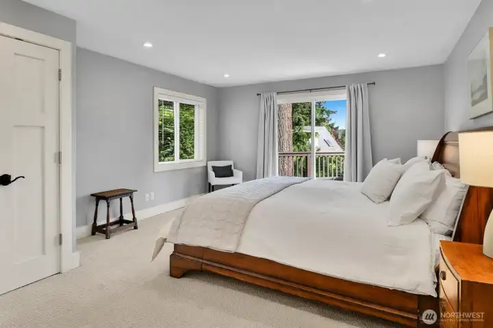 Primary Bedroom with French doors to the back deck. Primary Bedroom with French doors to the back deck.