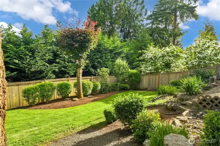 Terrific fenced backyard and a patio with table and chairs on this side. Terrific fenced backyard and a patio with table and chairs on this side.
