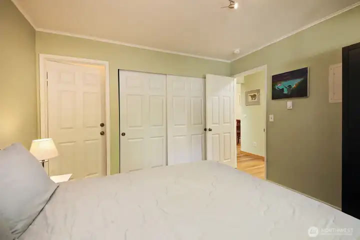 Two closets. One to the left is a deep walk in closet and the one to the right is a standard sized closet.