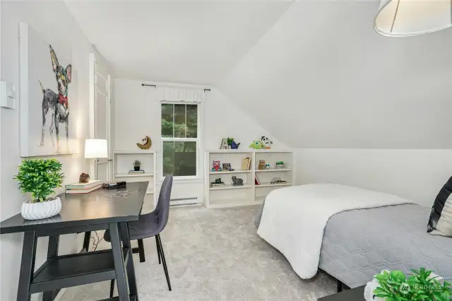The second upper level bedroom features custom built-ins and a generous walk-in closet space.