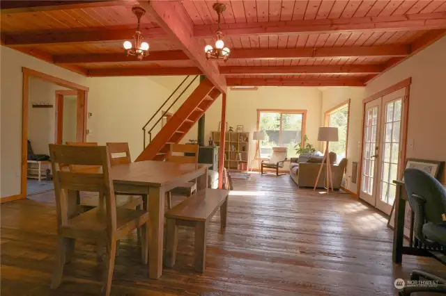 Timberframe design with rustic hand hewn hardwood flooring.