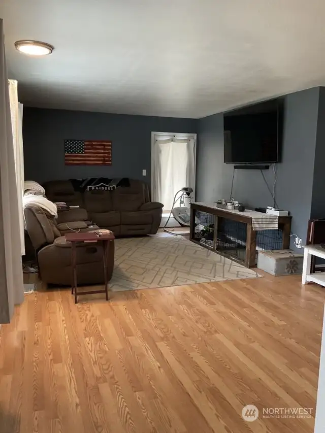 Living Room off to the left upon entering the home. Nice Large windows and a man door out to the porch.