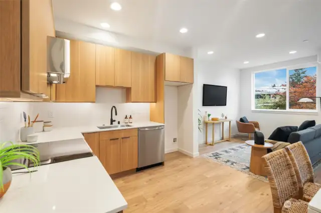 The Kitchen features Quartz Countertops, Full Height Tile Backsplash, Under cabinet Lighting and Stainless Appliances.   Photos are of a completely different floorplan and are representative of quality and finishes.  Color schemes vary by location.