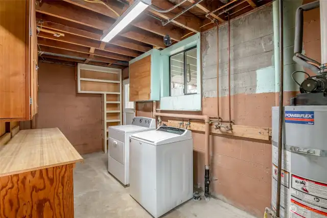 Large laundry room and storage area in the basement.