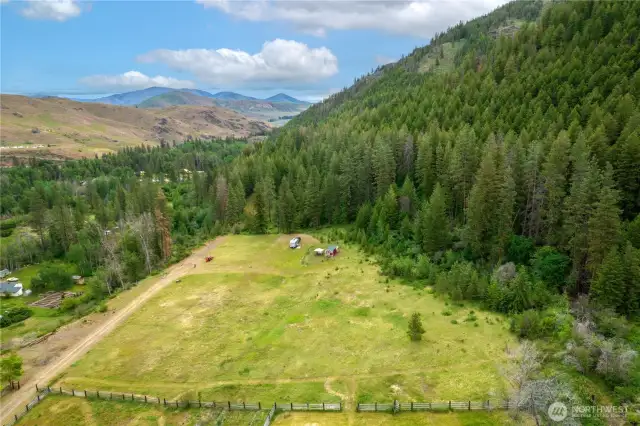 Comprised of two building parcels, the property includes level pasture and forested hillside.