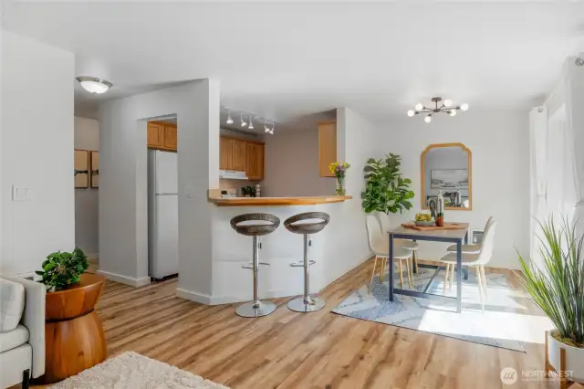 The kitchen features an eating bar that can seat more than two. The dining room, kitchen, and bathrooms have updated lighting.