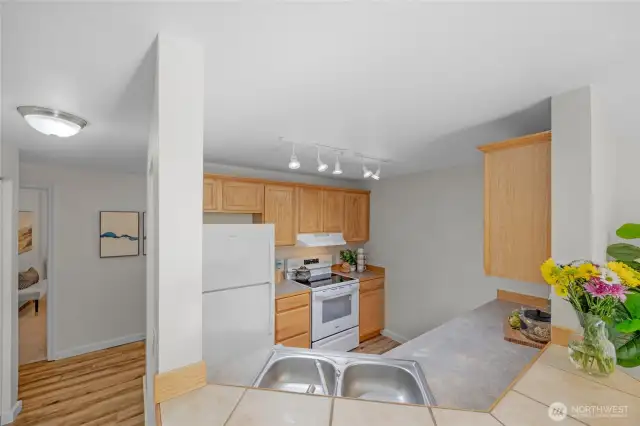 The good size kitchen with maple shaker style cabinets, good counter space, and double steel sink.  The range/oven and dishwasher are new.  The refrigerator is fairly new.