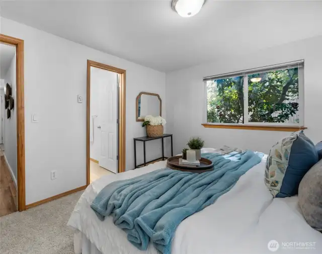 The primary bedroom with private full bathroom faces west.