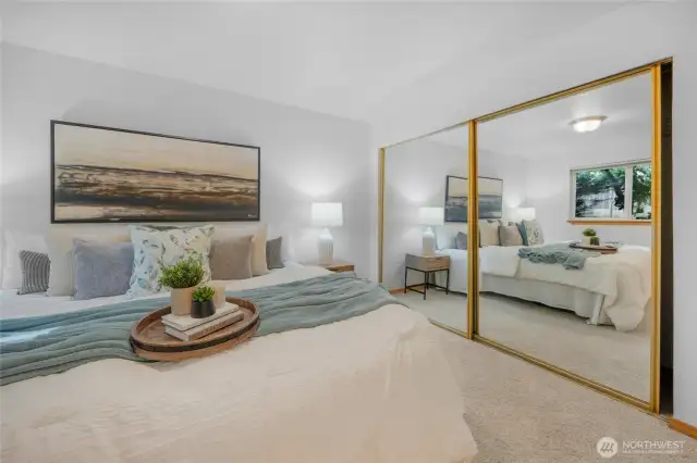 Double mirrored closet doors increase the spacious feel of the primary bedroom.