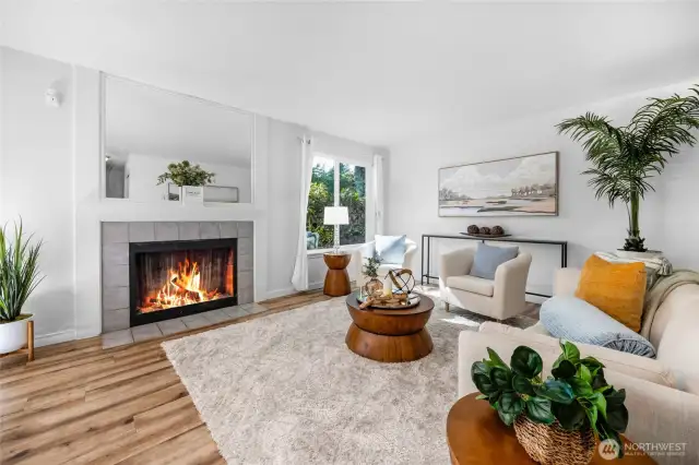 The living room features a wood burning fireplace with a ceramic tile surround and a mantle with mirror above.