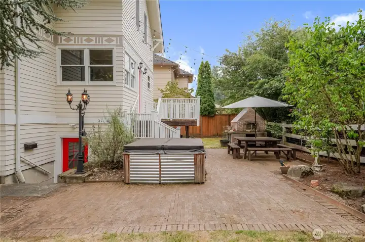 Patio with hot tub and pizza oven