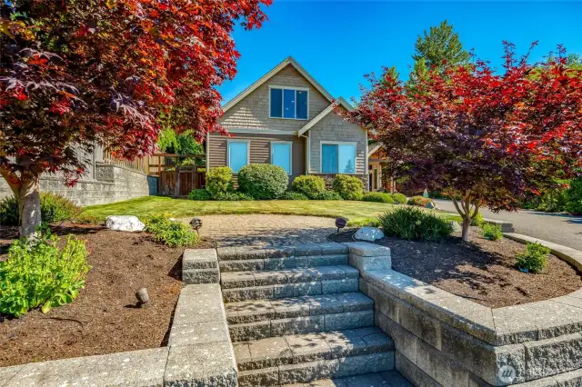The terraced front yard includes a patio area, perfect for outdoor furniture, some garden art or a fountain!