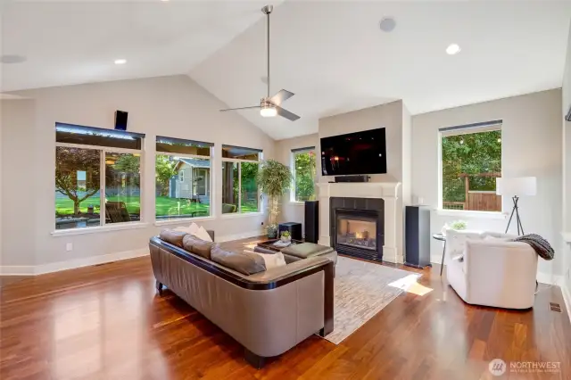 The light filled living room comes with the 4K LG OLED 65" television seen here, and a special mount allows for pulling the tv down for ease of viewing.  This home theater includes 10 speaker Dobly Atmos surround sound.