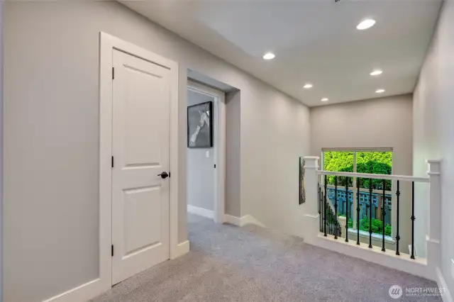 Second floor landing. Bonus room/4th bedroom door at center.  Linen closet left of center.