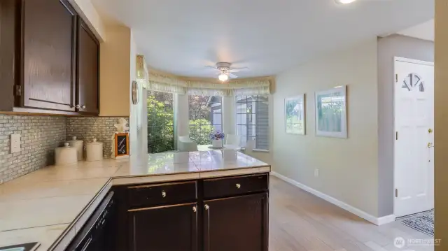 The kitchen is just steps to the entry and a large eating nook with a bow window that fills with light.