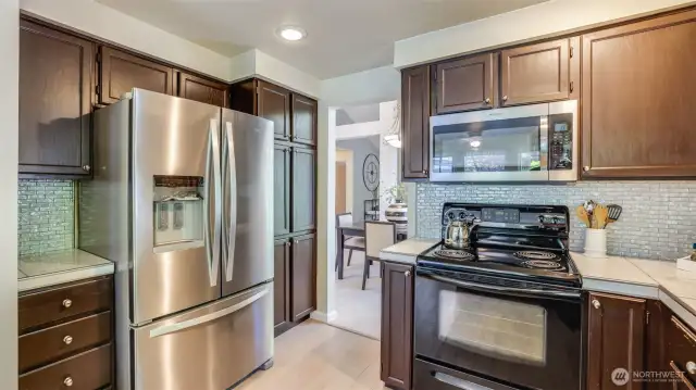 Stone countertops, glass tile backsplash and newer appliances.