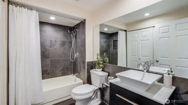 The 2nd bathroom has been updated with new tile, vanity and sink.  The utility room is behind the 2 doors.