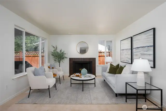 Living room with woodburning fireplace and large window