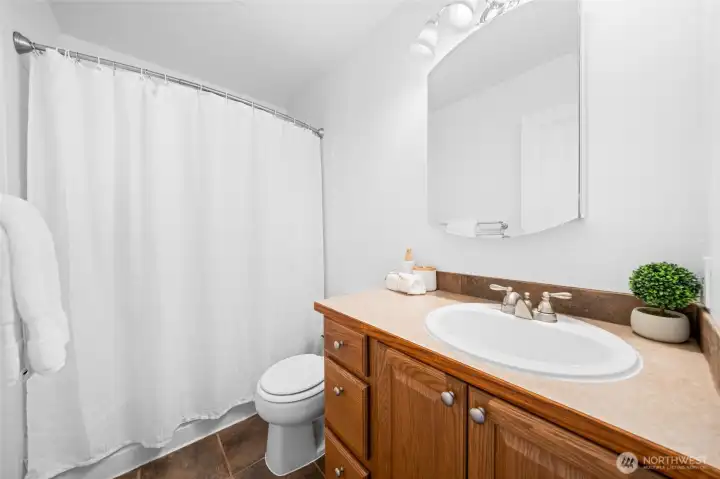 Secondary full bathroom on the third level.