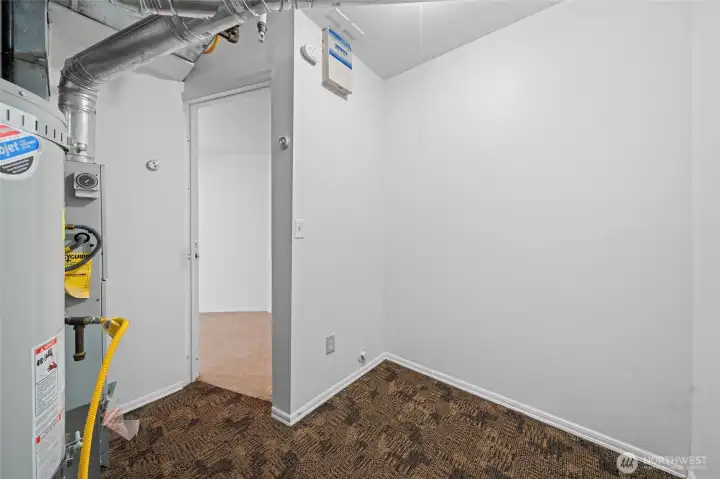 Furnace and water heater area with more additional storage space.