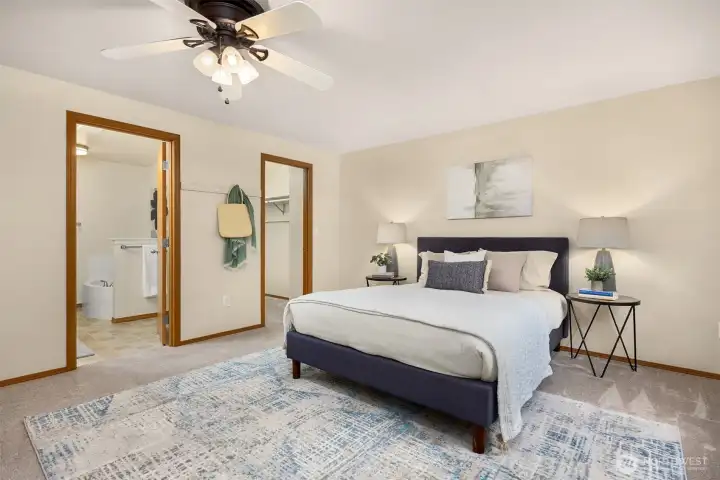 Primary bedroom with doors into the walk in closet and the primary bathroom.