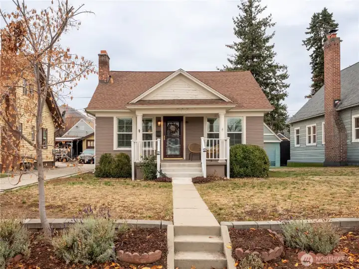 Front exterior of charming 1928 Craftsman bungalow with classic covered porch