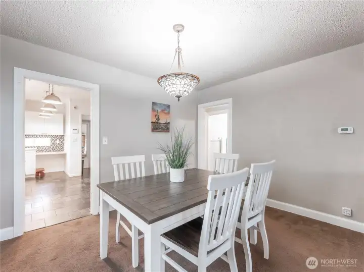 Dining area off updated kitchen with a surprise open-concept flow to the living room