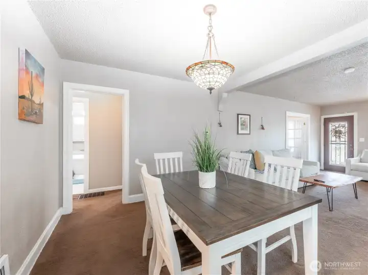 Dining room bridging updated kitchen and living room in an open, airy layout