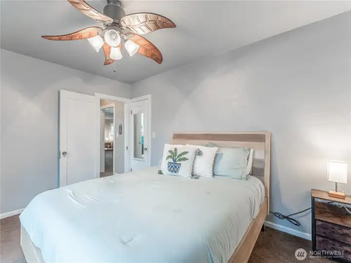 Primary bedroom offering natural light, closet, and ceiling fan