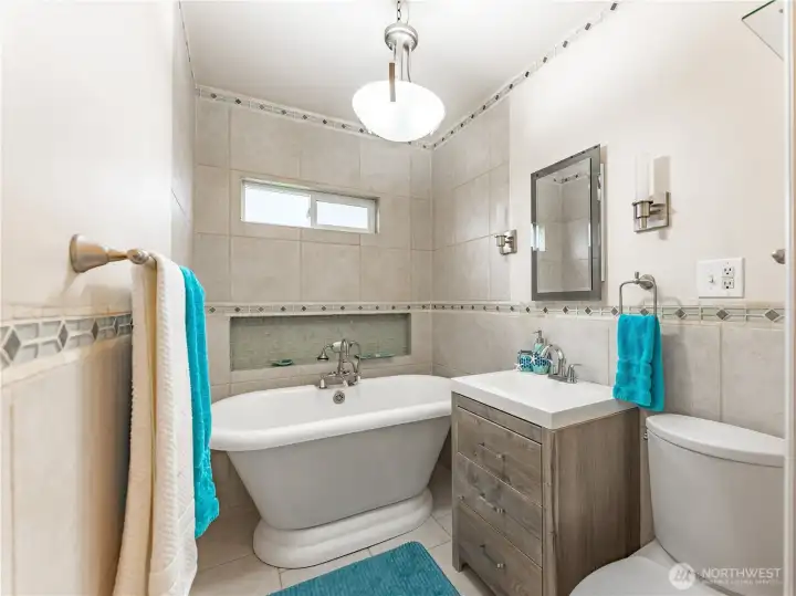 Main Bathroom with claw foot soaking tub & stunning tilework