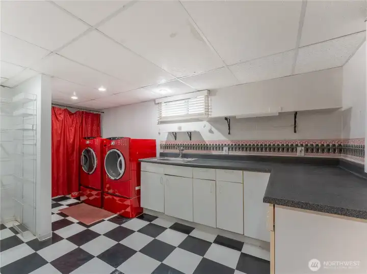 Expansive laundry room with space for second kitchen setup