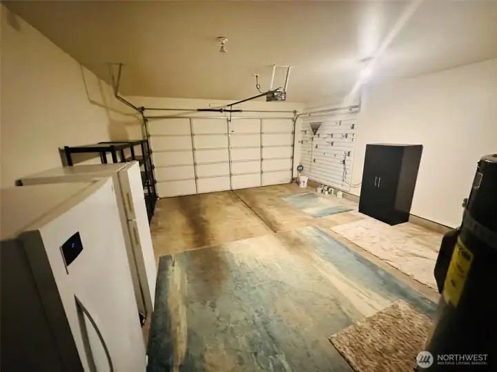 2-car garage with storage shelves and water filtration system