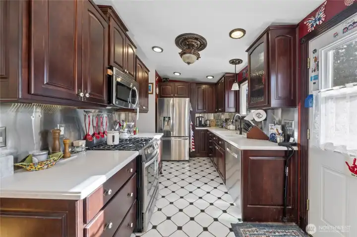 Beautiful cherry cabinets and marble looking corian counters
