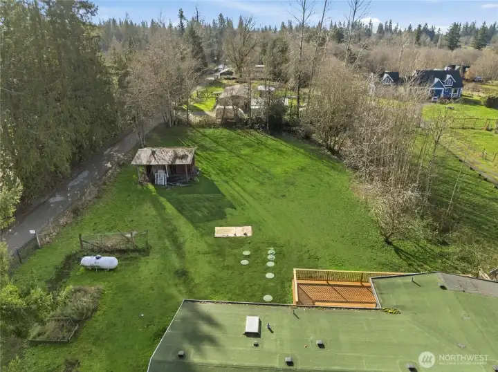 View just off the roof at the back yard. Ample room for gardens or a small animal farm~