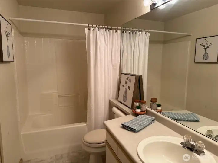 Second floor bathroom with new flooring and another large vanity.