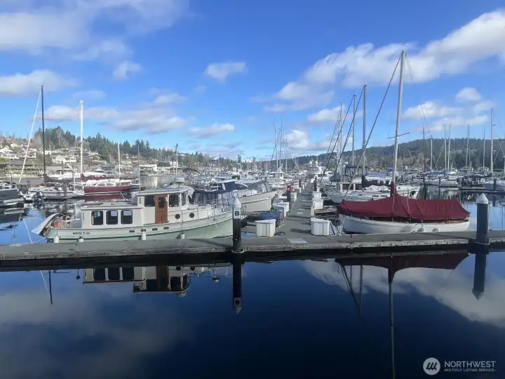 Downtown Gig Harbor marina slip at Murphy’s Landing with Mount Rainier backdrop, Puget Sound boating access, and walkable waterfront lifestyle.
