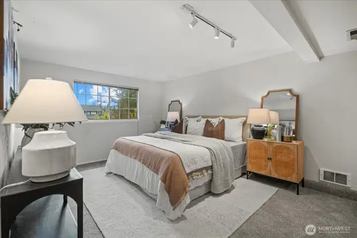 The primary bedroom is bright and invitinng.