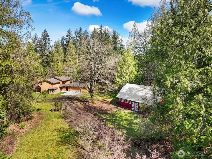 A private, secluded country lifestyle featuring a four-stall red barn.