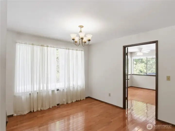 The dining room flows effortlessly into a sun-drenched breakfast nook and kitchen, allows activities to move smoothly around during busy mornings or grand holiday gatherings.