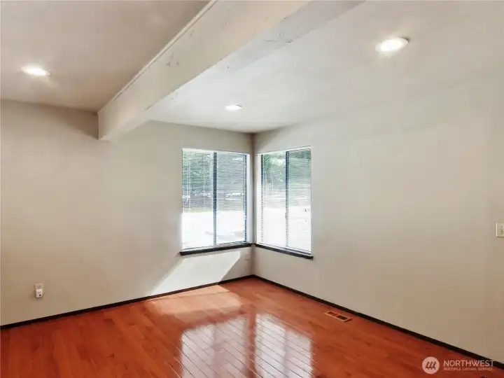 An inviting family room connects seamlessly, featuring peaceful backyard views and ocasional visits from local wildlife.