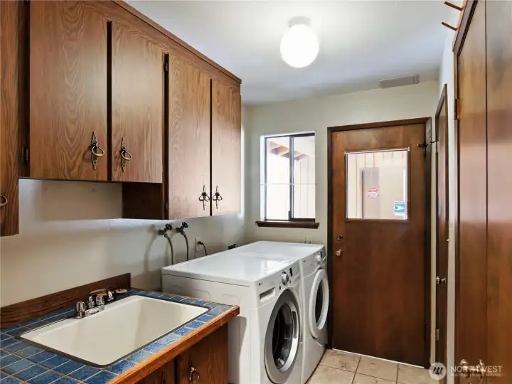 Utility/Mud room with wash sink and toilet closet is a buffer for mess.