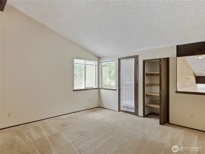 Retreat to the primary suite, where high ceilings create an airy feel and a private deck provides the perfect spot to enjoy peaceful outdoor views.