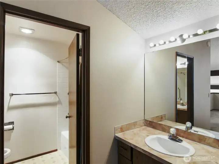 A well-appointed primary bathroom includes separate vanities, blending effortless organization with daily functionality.