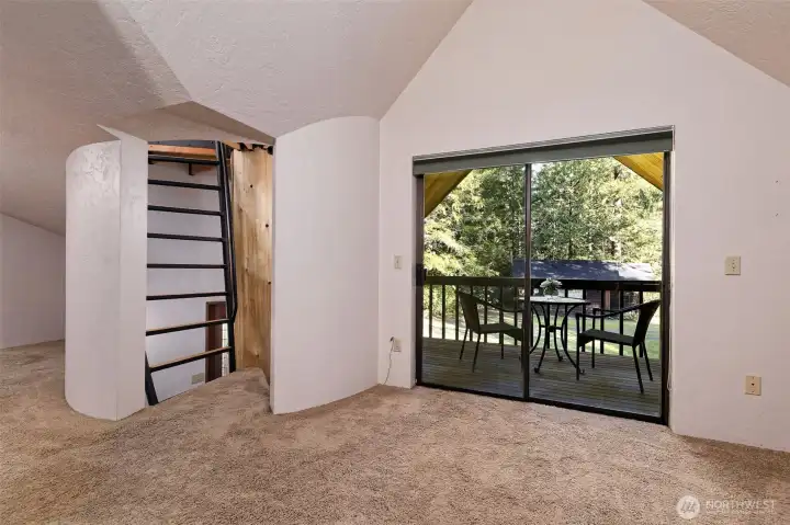 This is upstairs in the rec room, and the "ladder" leads you up into the tower. The sliding glass doors lead out to a really nice deck.