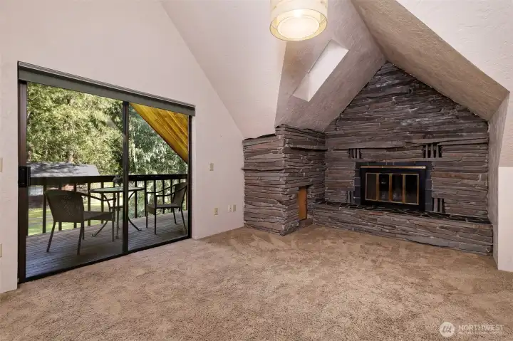 This is the fireplace and deck off of the rec room upstairs. Beautiful stone fireplace with a blower.