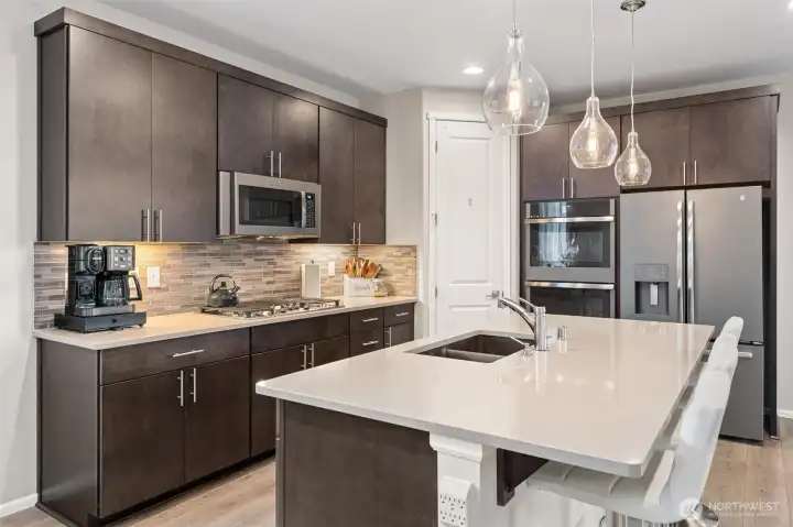 Large center island with sparkling pendant lighting