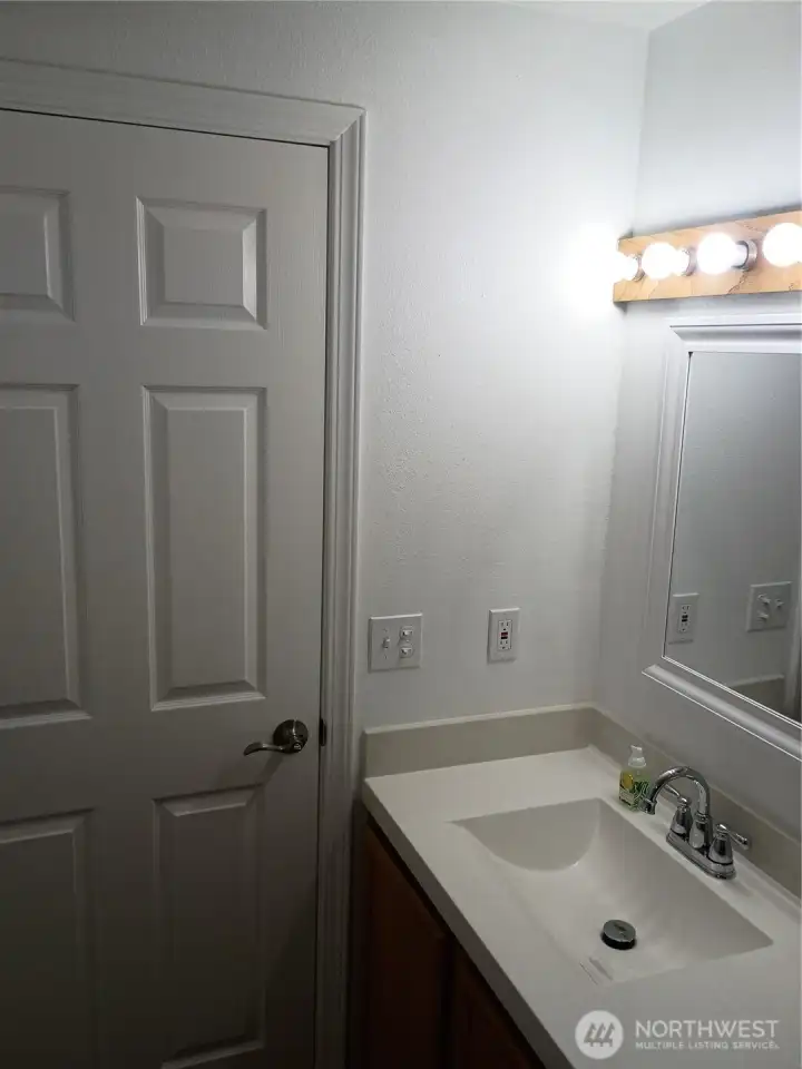 Bathroom with new countertop with integral sink and new 6 panel door