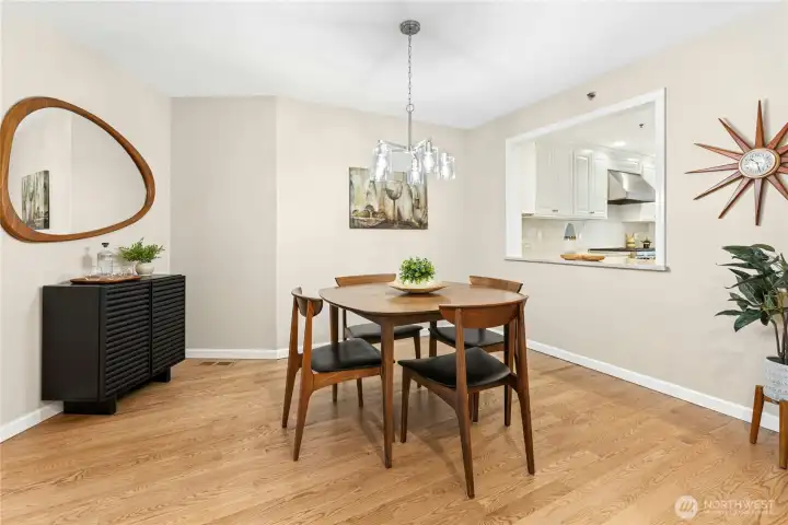 The dining room has a new light fixture and a convenient pass-through to the kitchen. The dining room has a new light fixture and a convenient pass-through to the kitchen.